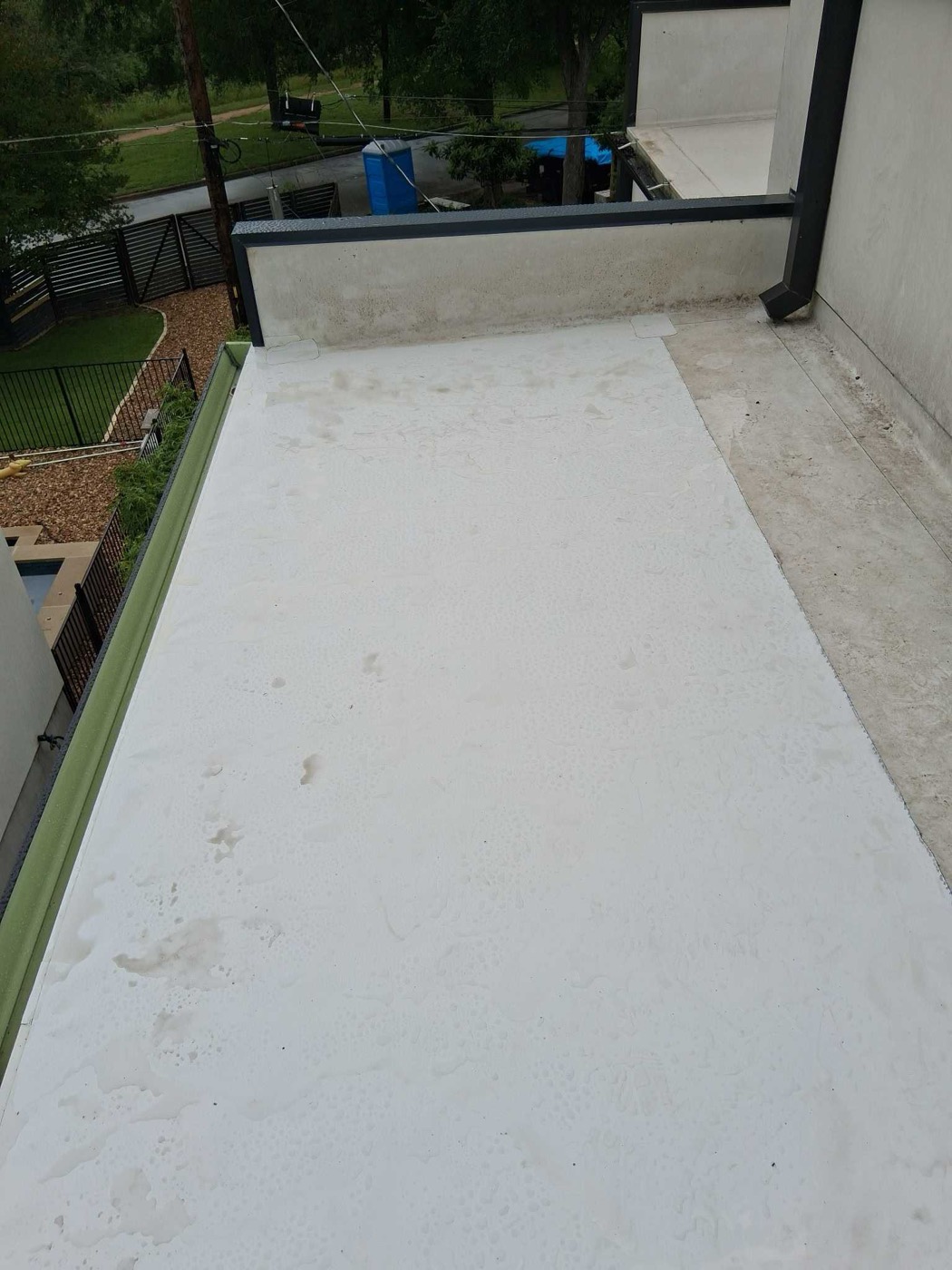 White TPO membrane installed on a flat balcony roof in Austin with downtown view