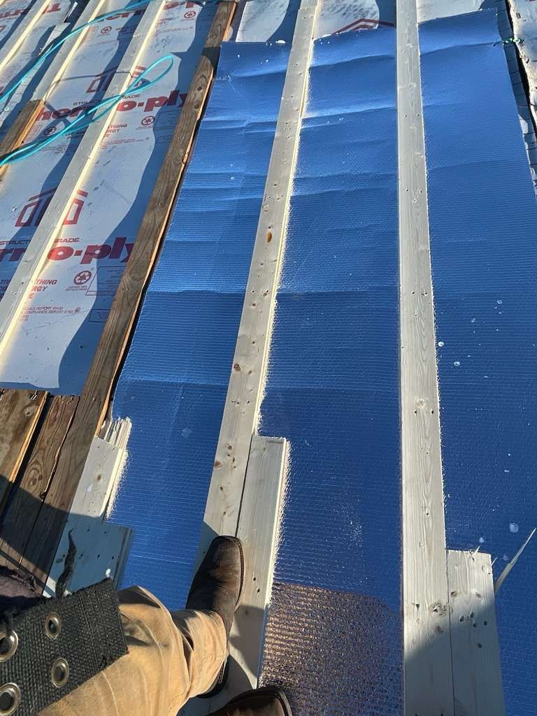 Blue ridge venting and wood furring strips bedded onto the deck before metal panels go down