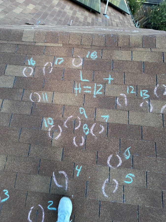 Ten-square-foot hail test square chalked out on an architectural shingle field with every confirmed hit circled
