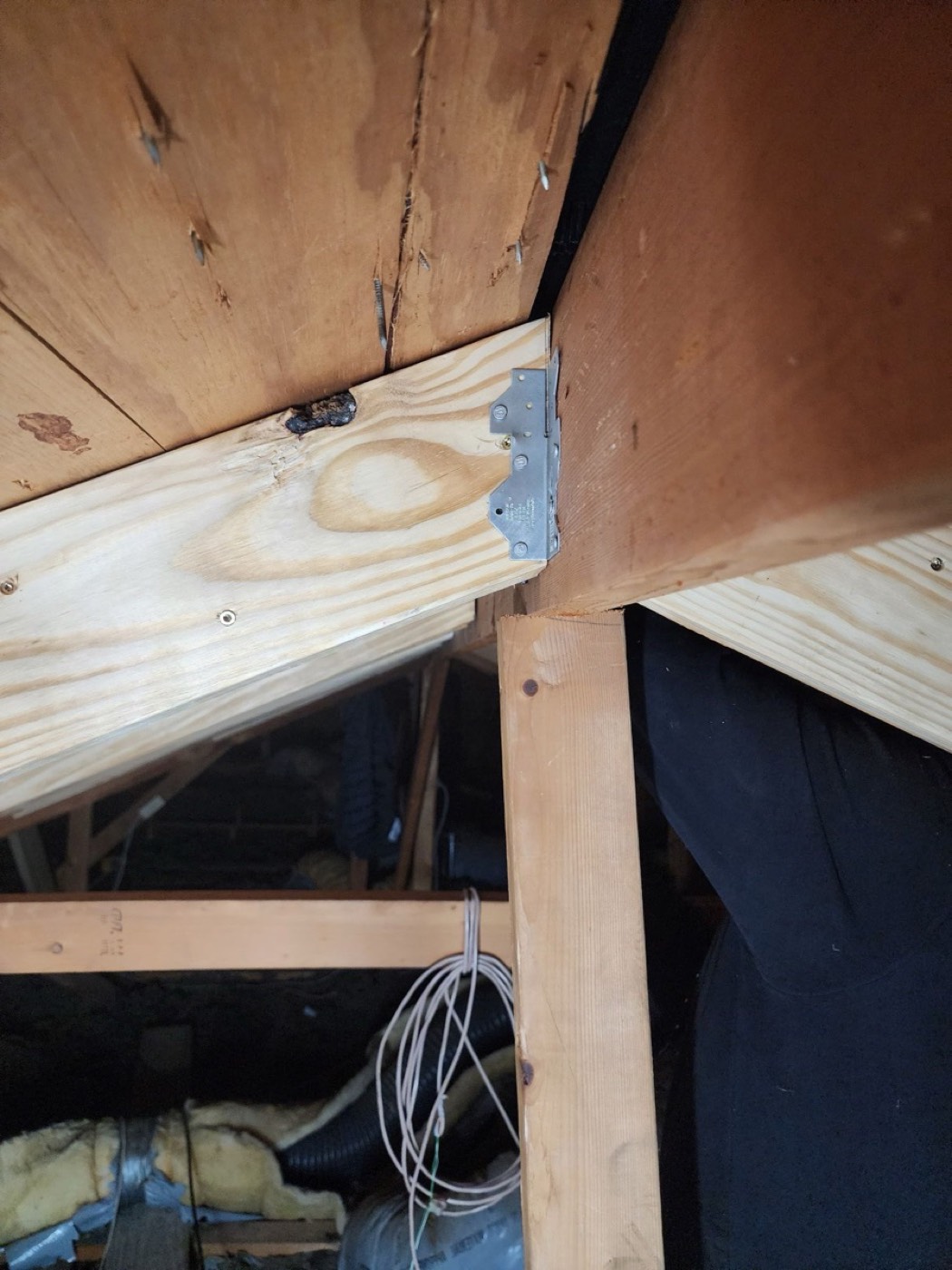 New sister rafter installed alongside the original framing on El Rey Blvd with a Simpson Strong-Tie connector plate fastened to IRC R802 specification.