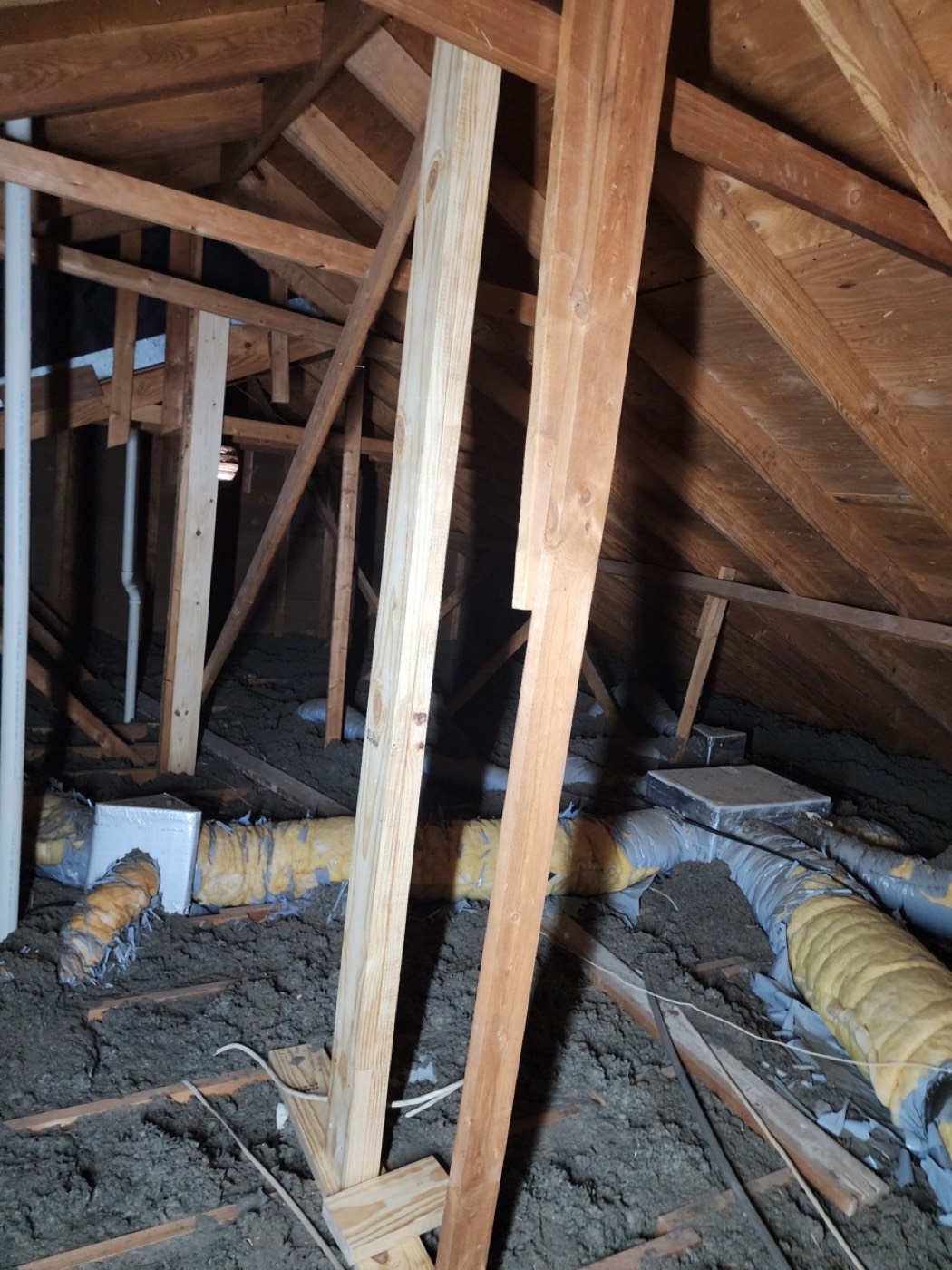 Interior attic view on El Rey Blvd showing original rafter framing with blown-in insulation and HVAC ducting before structural repair.